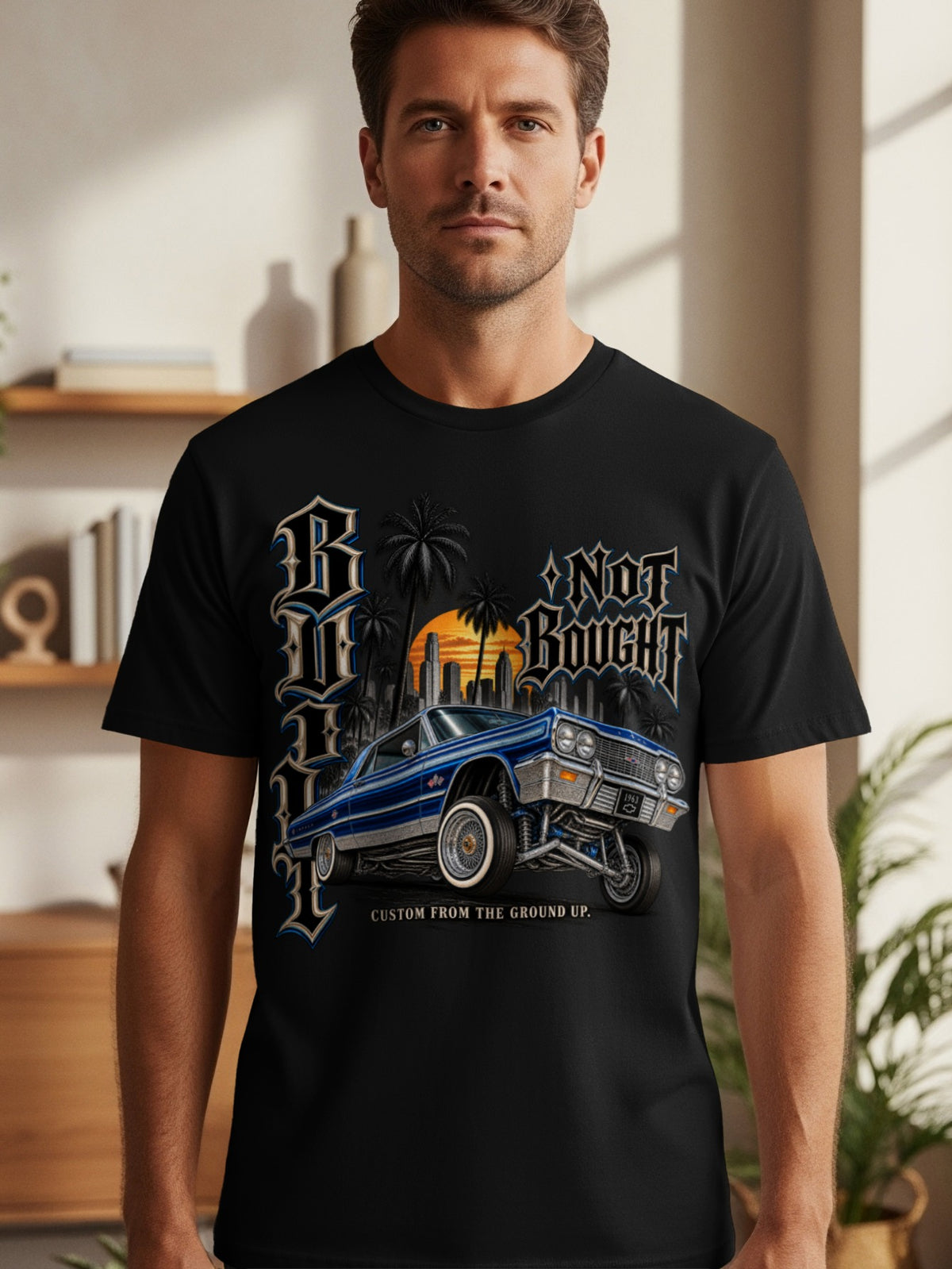 Black t-shirt with a blue custom car, palm trees, city skyline, and text.