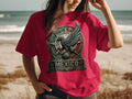 Red t-shirt featuring a circular emblem with an eagle and 