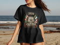 Black t-shirt with 2026 World Cup logo featuring flags, soccer ball, and roses.