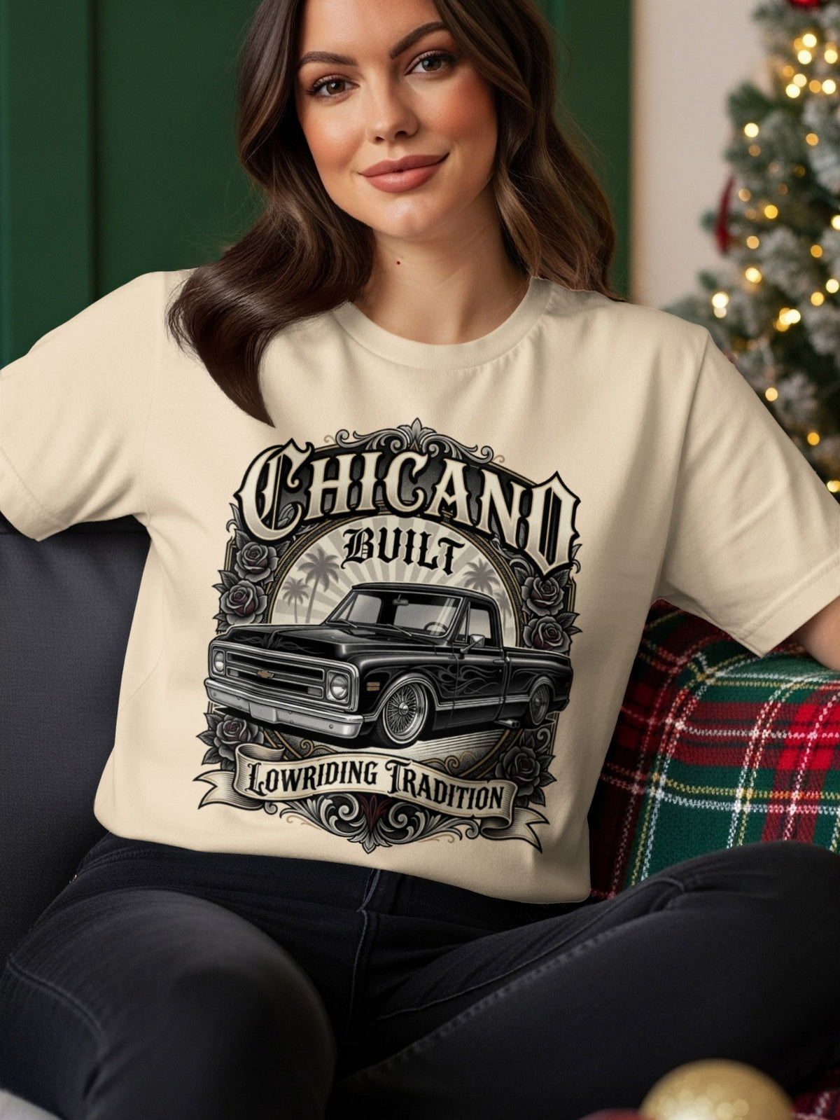 Cream t-shirt with "Chicano Built Lowriding Tradition" and a black lowrider truck graphic.