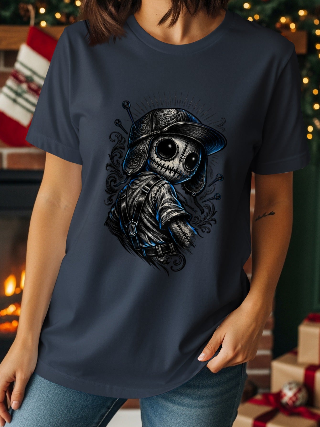 Dark blue t-shirt featuring a stylized doll character with stitch details.