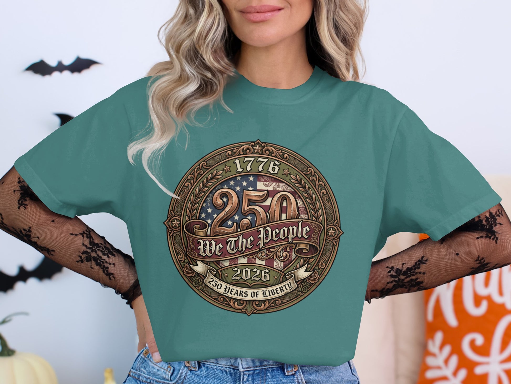 Teal t-shirt featuring a circular patriotic design with "1776 250 WE THE PEOPLE 2026 250 YEARS OF LIBERTY".