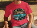 Red t-shirt with graphic of teal classic truck and text 
