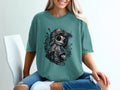 T-shirt with graphic of a dark, stitched doll wearing a baseball cap.