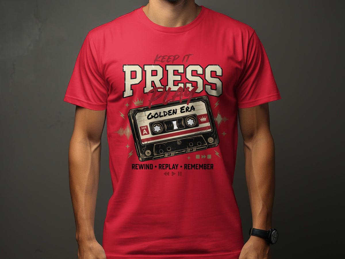 Red t-shirt with "Keep It Press Play Golden Era" text and cassette tape graphic.