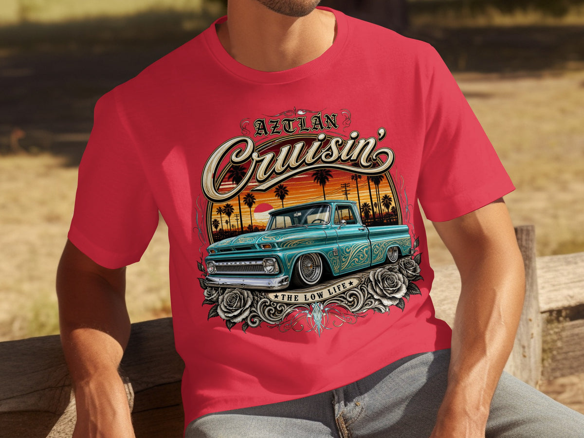 Red t-shirt featuring "Aztlán Cruisin'" text and a teal lowrider truck with roses.