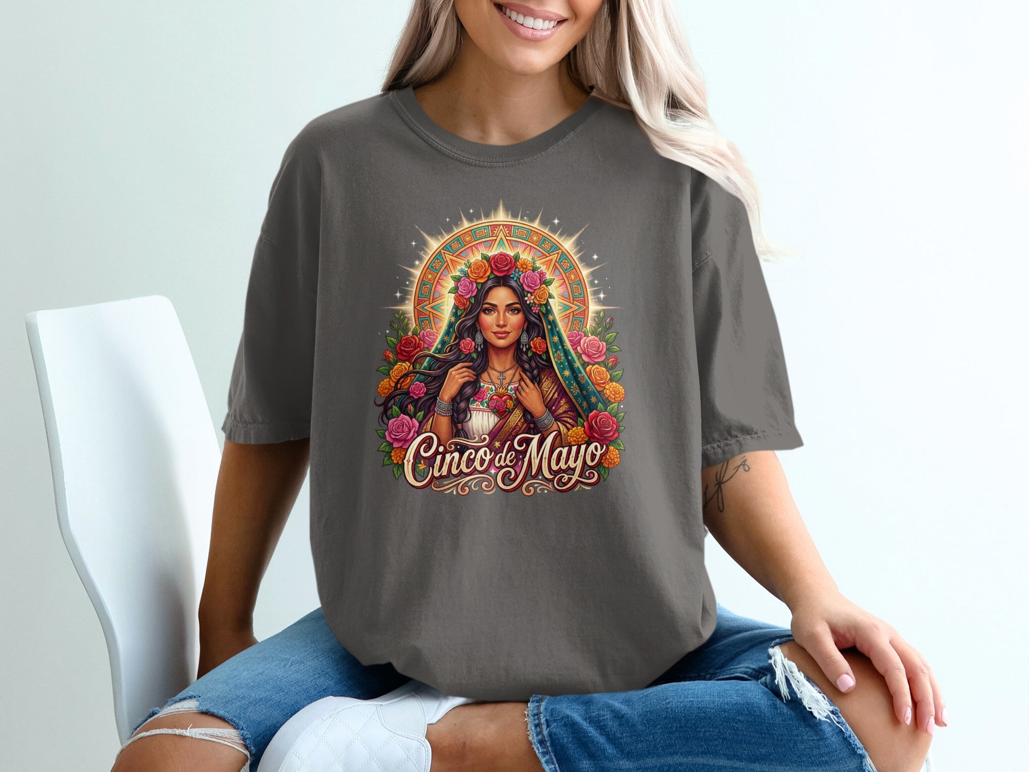 Woman wearing a dark grey t-shirt with a vibrant religious design.