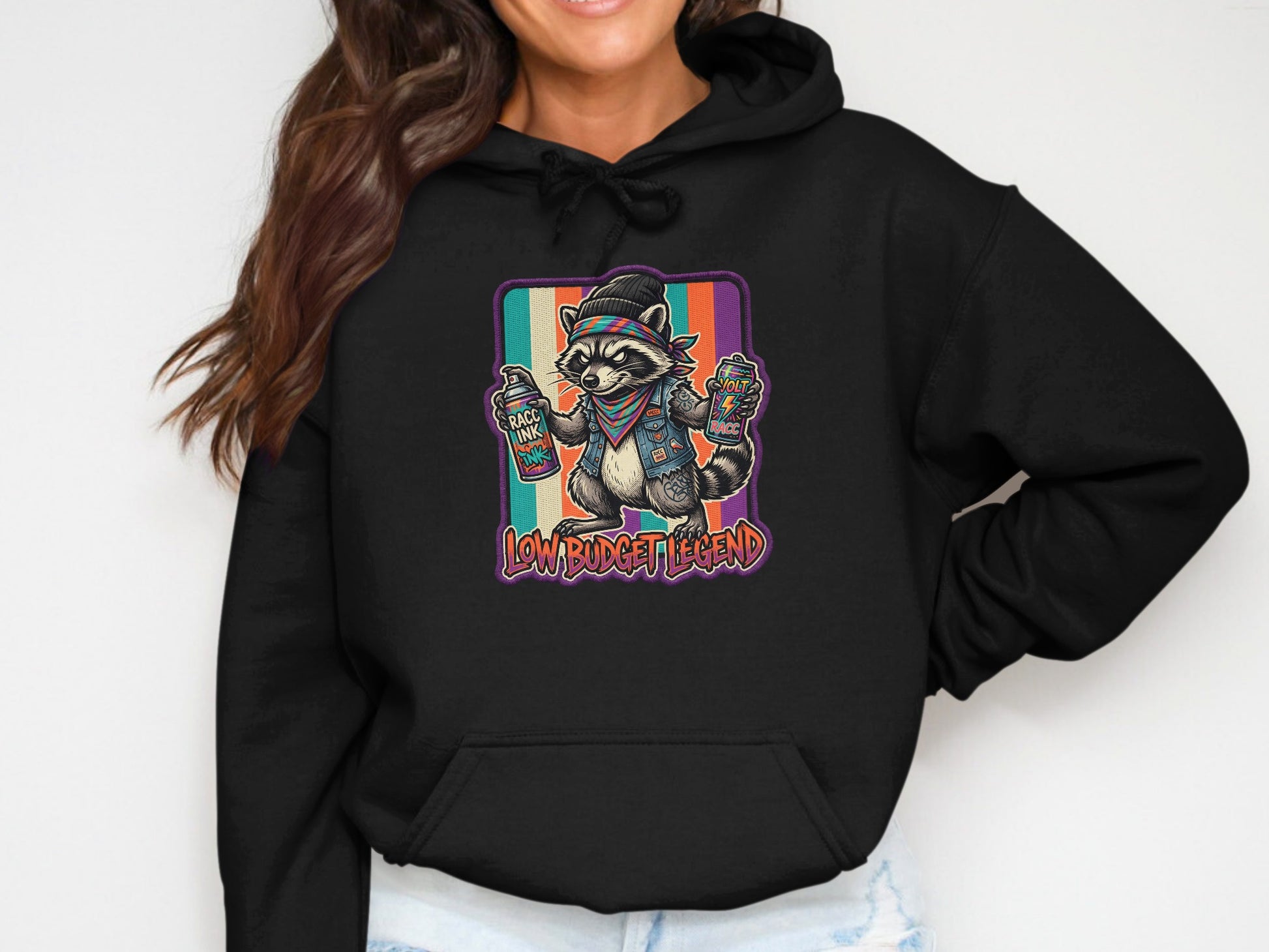 Raccoon wearing bandana, holding spray paint cans, with "Low Budget Legend" text.