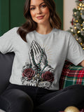 Grey t-shirt with graphic of praying hands, rosary, roses, crucifix, and the word 
