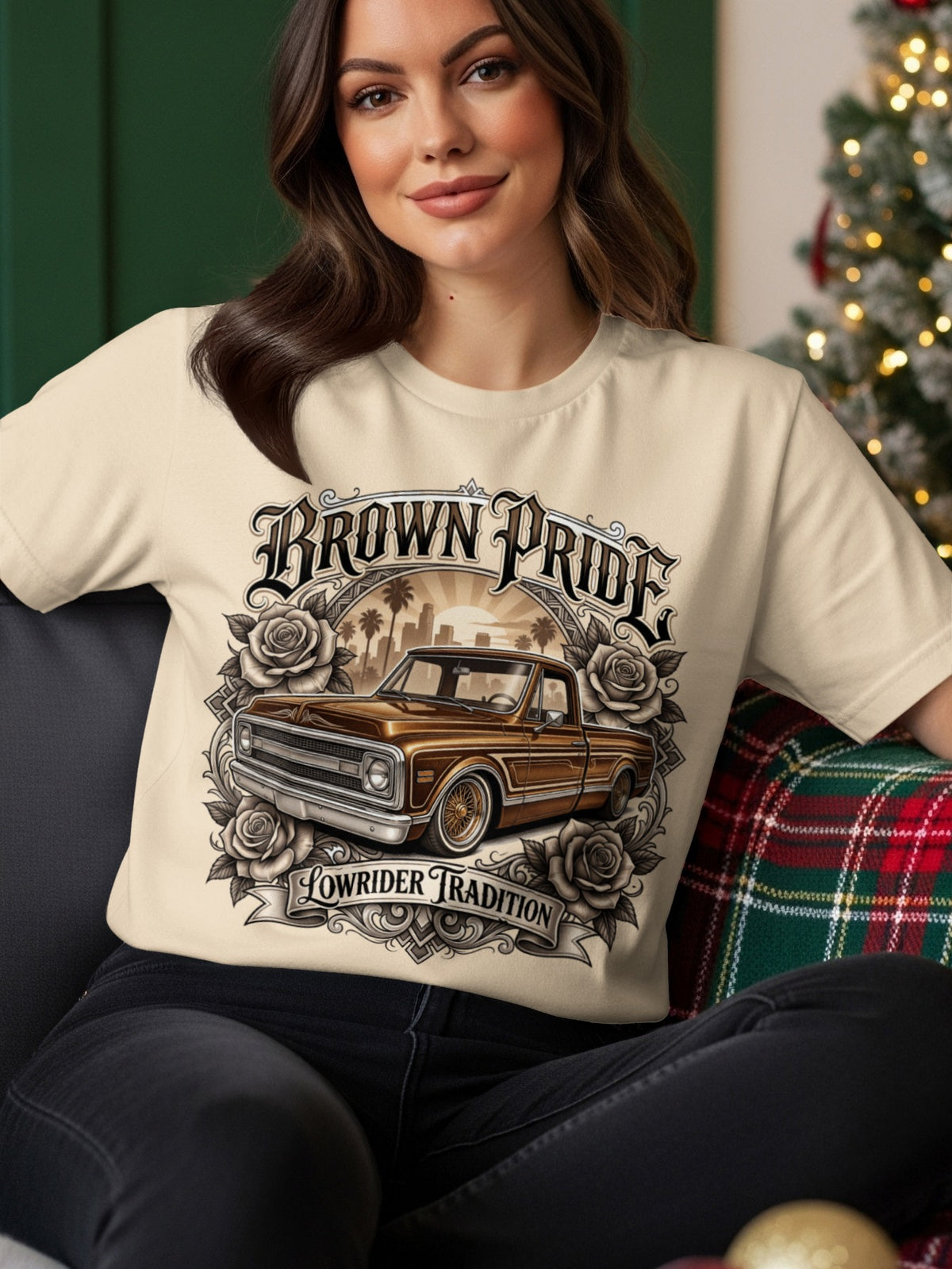 Cream t-shirt with "Brown Pride Lowrider Tradition" graphic featuring a vintage truck and roses.