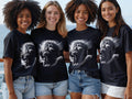 Four women wear black t-shirts with a detailed depiction of Jesus Christ.