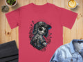 T-shirt with a stylized, spooky doll graphic wearing a hat and overalls.