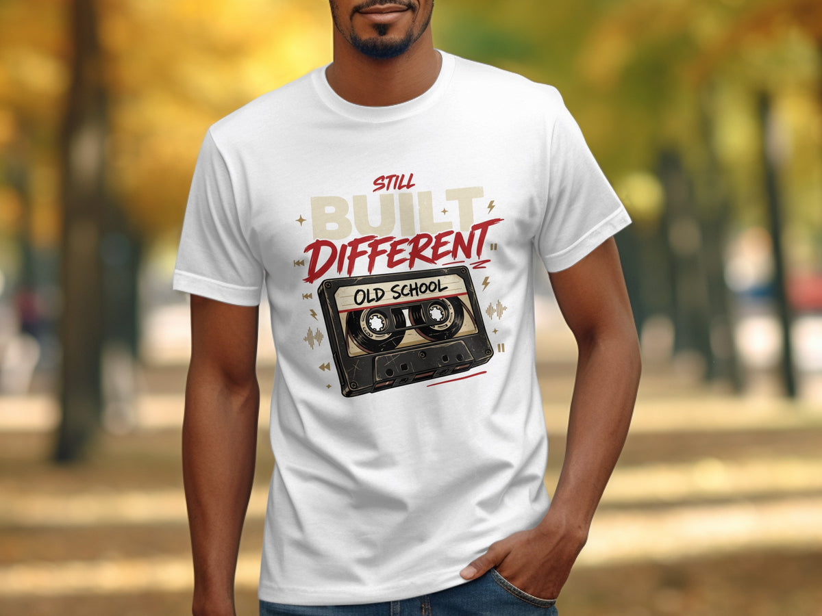 White t-shirt with "STILL BUILT DIFFERENT OLD SCHOOL" and cassette tape graphic.