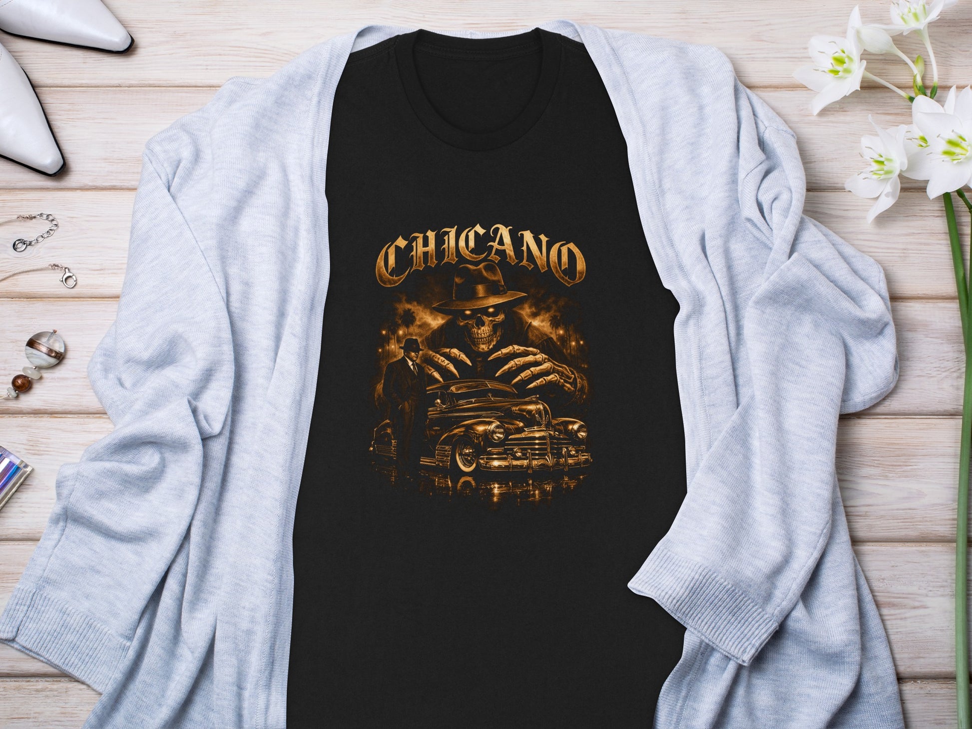Black t-shirt with "Chicano" text and skeletal driver in vintage car.