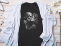 Black t-shirt featuring a sugar skull couple kissing, adorned with roses.