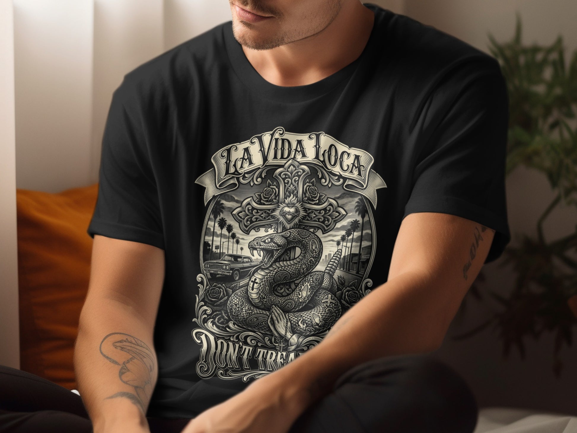 Black t-shirt with La Vida Loca snake and cross graphic.