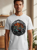 White t-shirt featuring a graphic with a lowrider bicycle, sunset, and text.