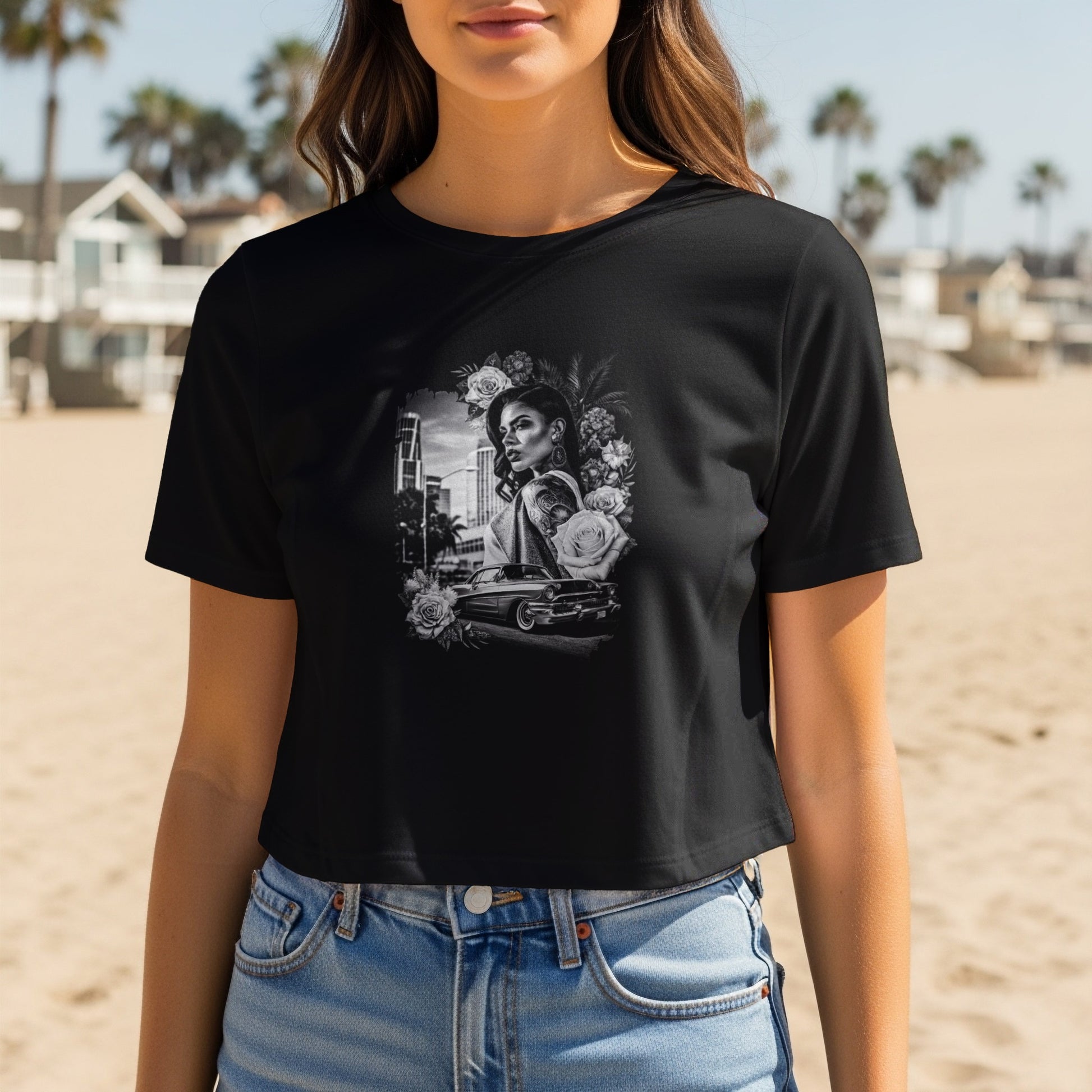 Black t-shirt with graphic of woman, roses, and classic car on beach.