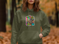 Olive green hoodie with raccoon, coffee, and 