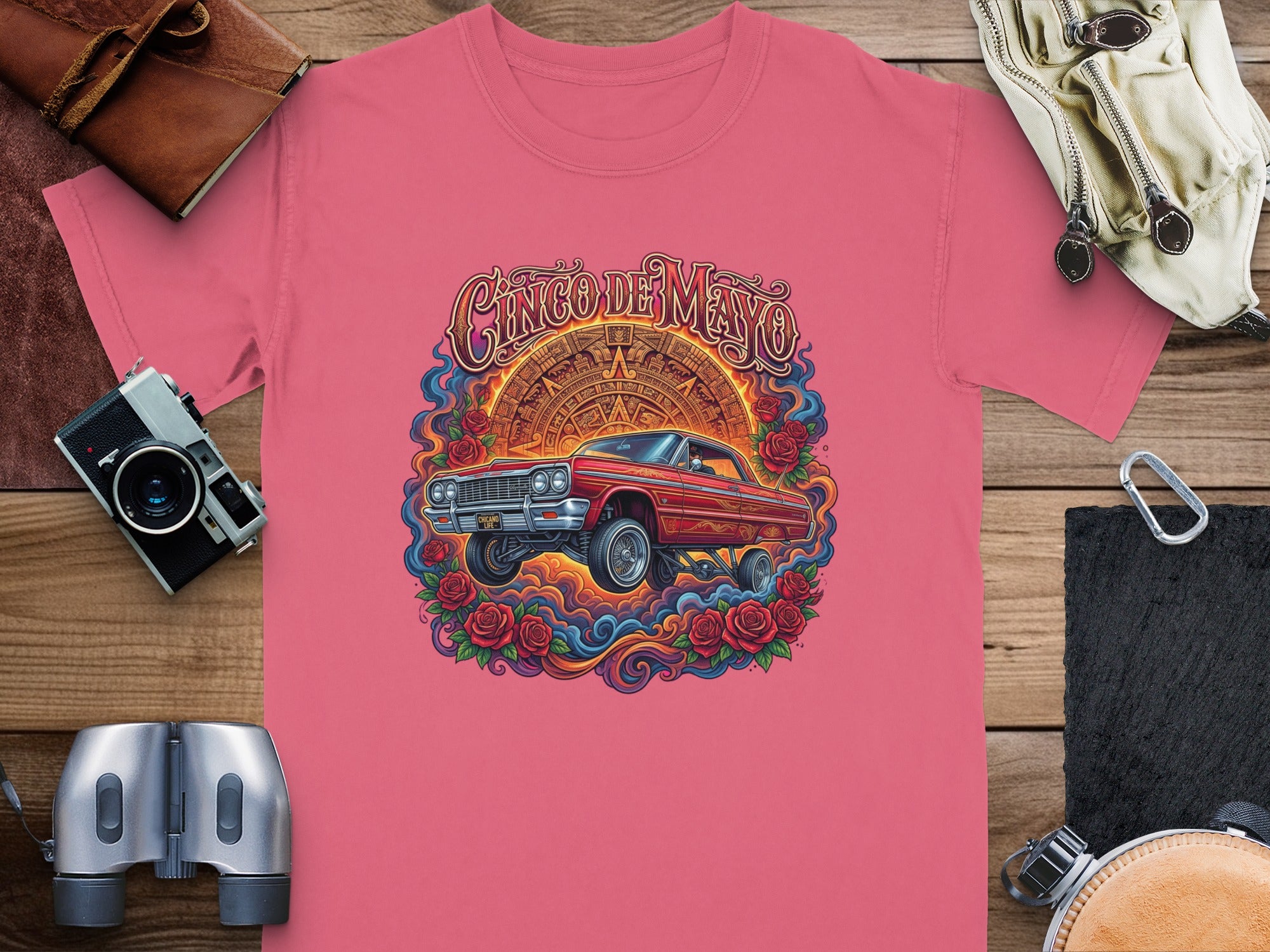 Cinco de Mayo graphic with red car and roses on a pink t-shirt.