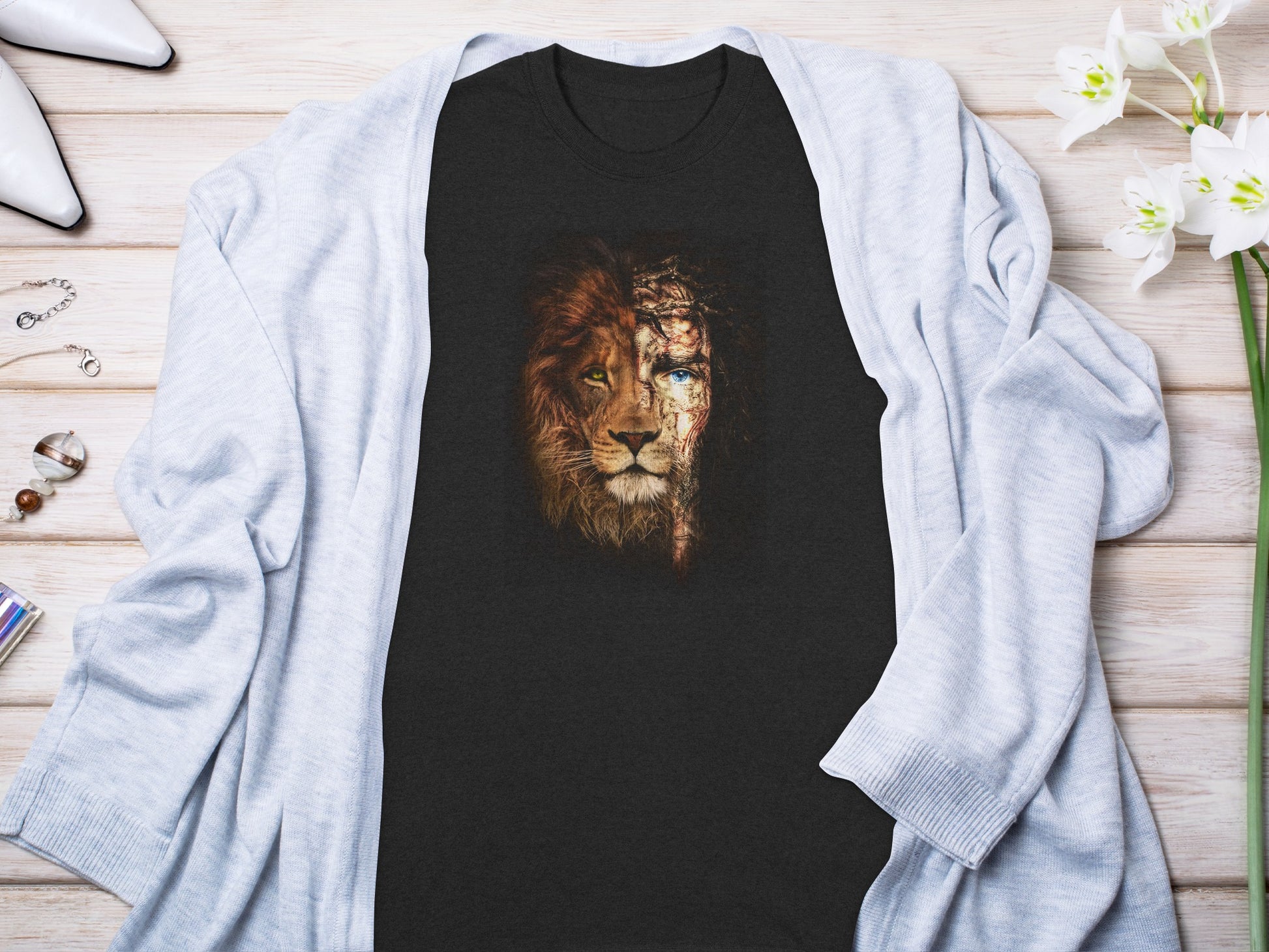 Dark t-shirt with graphic of lion's head with crown of thorns overlay.