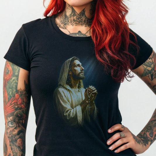Jesus praying, rendered on a black t-shirt with glowing light.