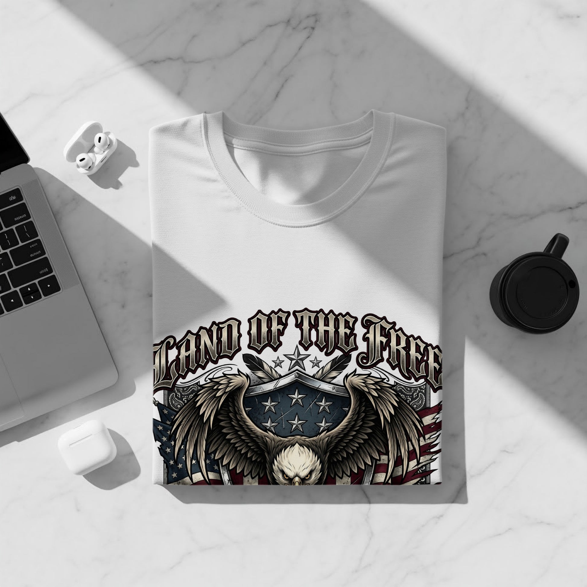 White t-shirt with "Land of the Free" eagle graphic and American flag design.