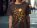 Woman in lowrider shirt with bicycle and classic car under moon.