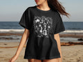 Black t-shirt with stylized artwork of women and 