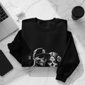 Black sweatshirt with Day of the Dead couple design and Yankees hat.