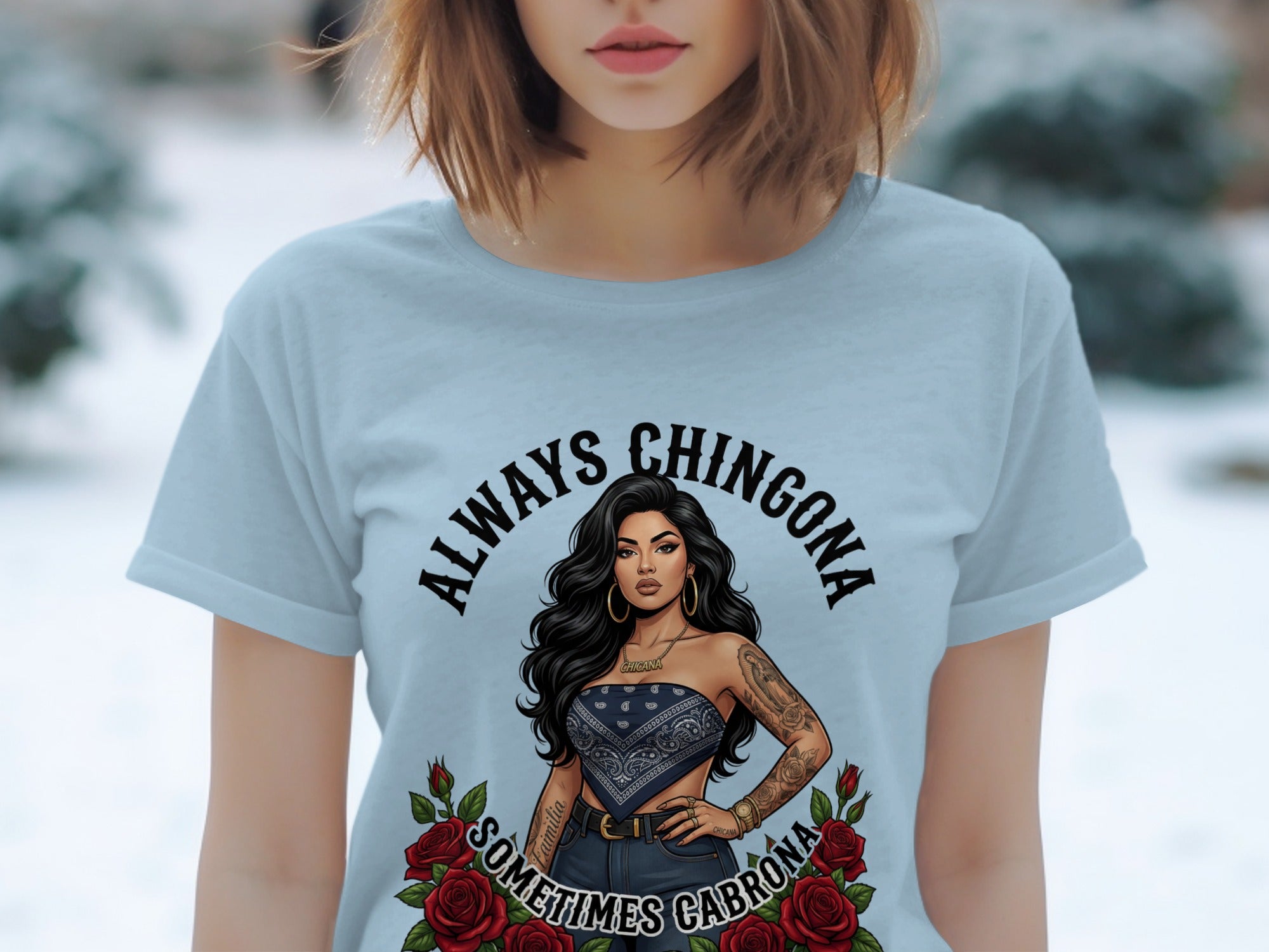 Light blue t-shirt with "ALWAYS CHINGONA SOMETIMES CABRONA" text and woman illustration.