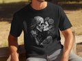 Black t-shirt with Day of the Dead skulls kissing, adorned with roses and tattoos.