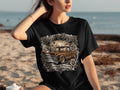 Black t-shirt with a graphic featuring a brown lowrider truck, roses, and text 