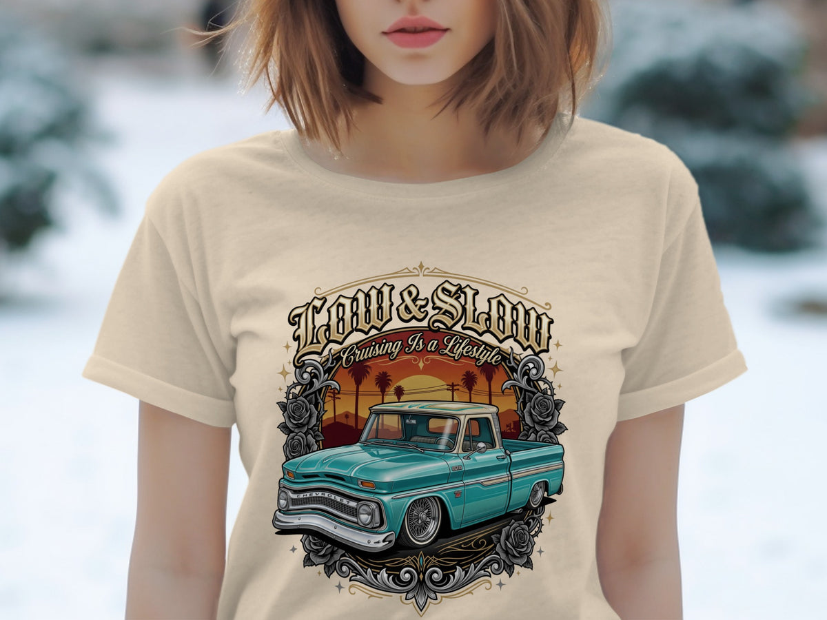 T-shirt graphic: teal vintage Chevrolet truck, palm trees, sunset, text "Low & Slow Cruising Is A Lifestyle".