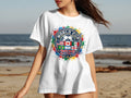 White t-shirt with FIFA World Cup 2026 logo featuring flags and colorful paint splatters.