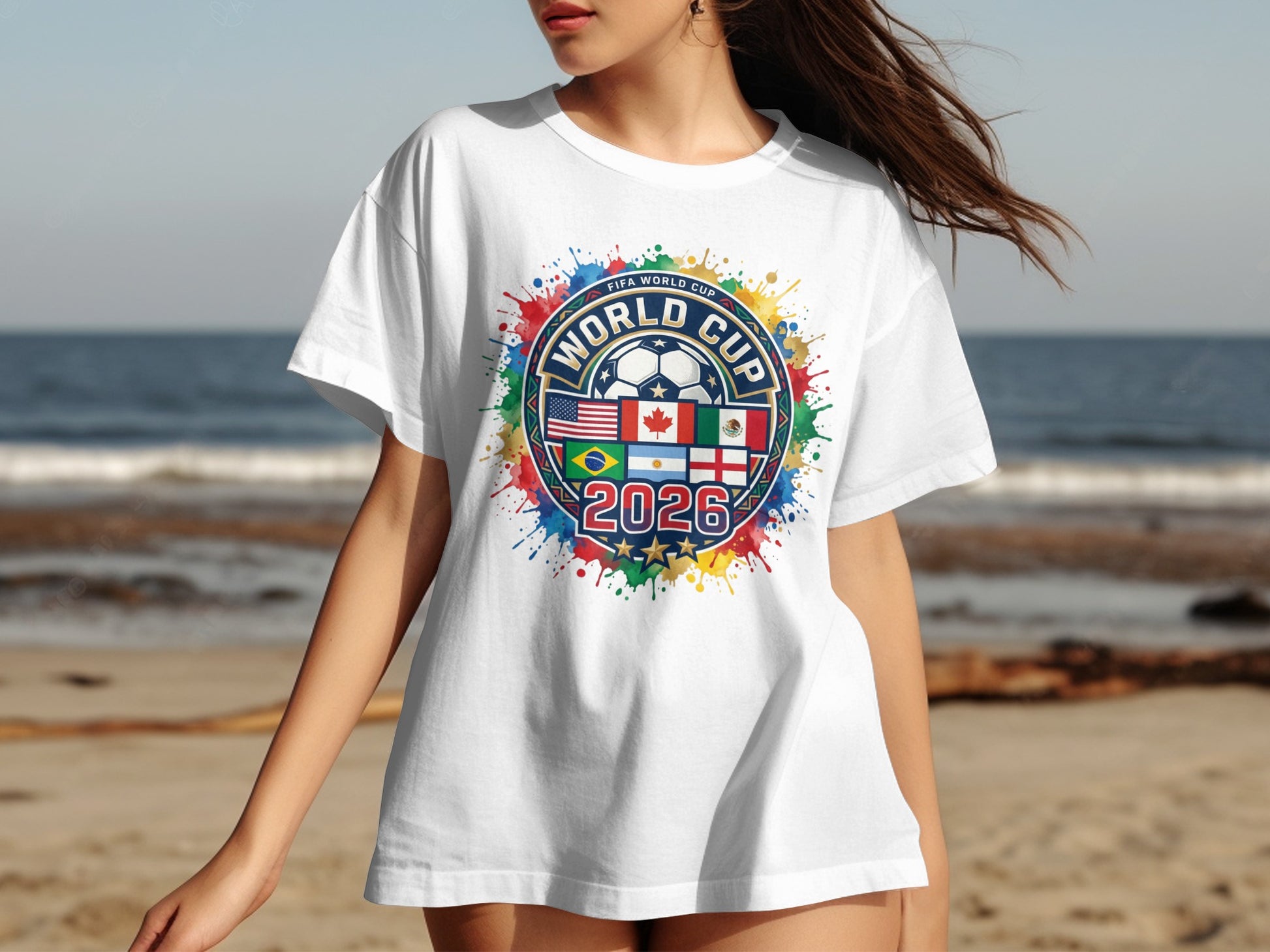 White t-shirt with FIFA World Cup 2026 logo featuring flags and colorful paint splatters.