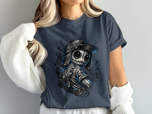 T-shirt with a detailed doll illustration wearing a baseball cap and backpack.