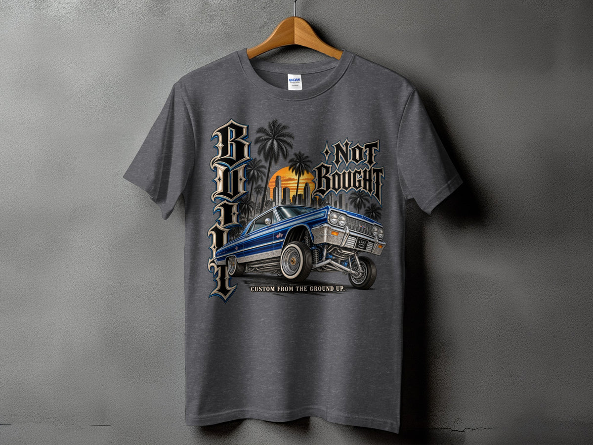 Grey t-shirt with a graphic of a blue lowrider car, palm trees, city skyline, and text.