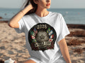 White t-shirt with 2026 World Cup crest featuring flags and soccer ball.