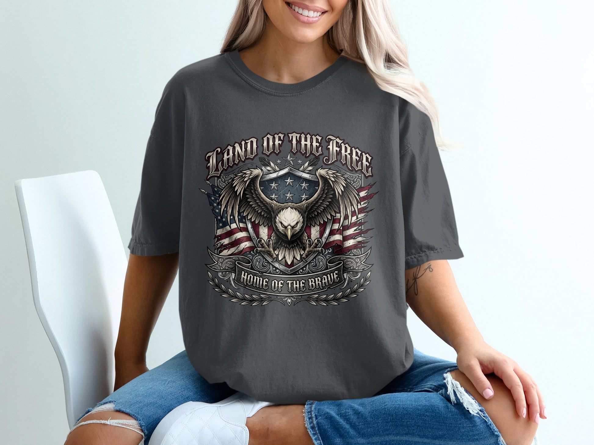 Dark t-shirt with eagle, flag, and "Land of the Free, Home of the Brave" text.