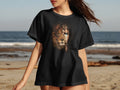 Black t-shirt with a lion's face splitting into a human face.
