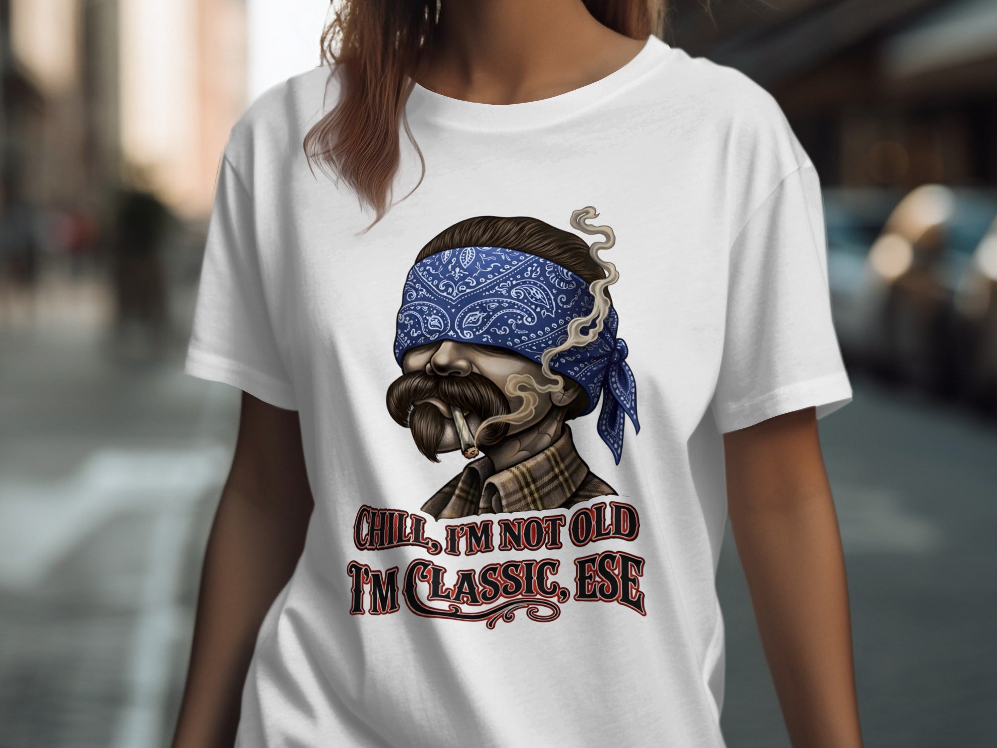 T-shirt with graphic of man wearing bandana and smoking, text "Chill, I'm not old I'm classic, ese".