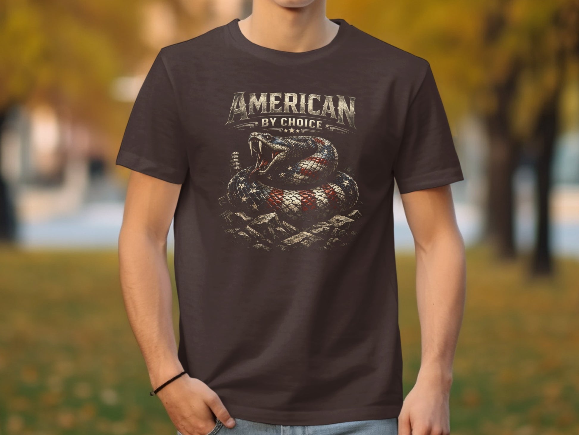Brown t-shirt featuring a coiled snake with American flag pattern and "AMERICAN BY CHOICE" text.