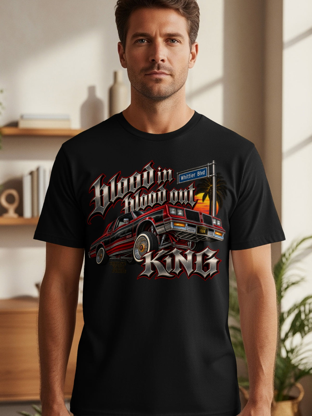 Black t-shirt graphic with red lowrider, palm tree, sunset, and text.