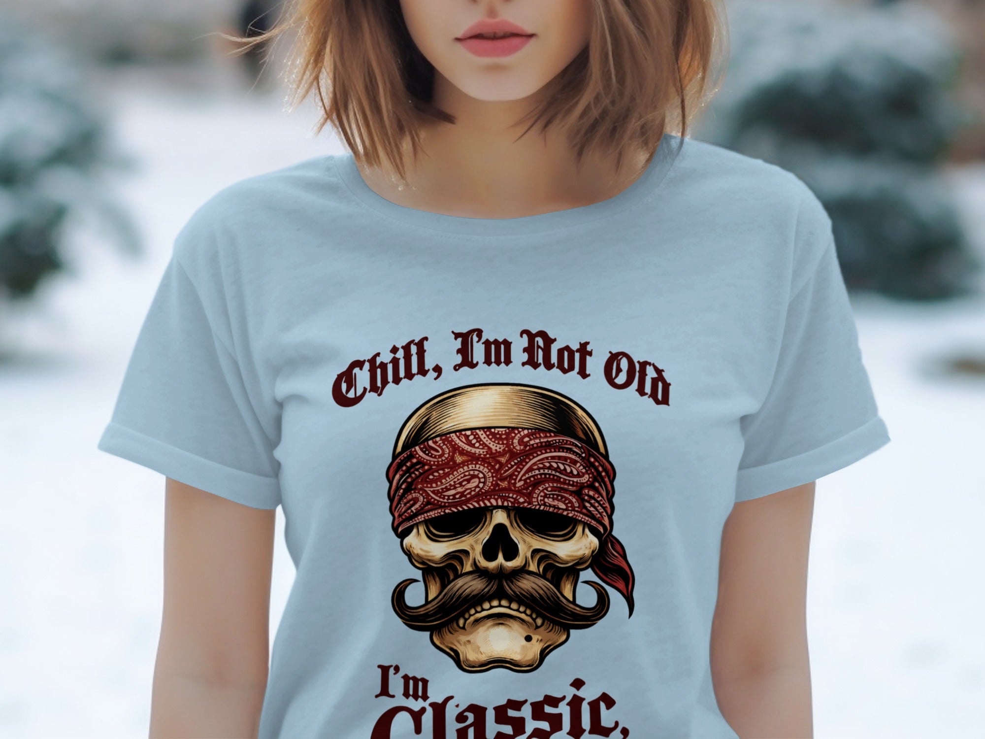 Light blue t-shirt with "Chill, I'm Not Old" and skull with bandana and mustache.